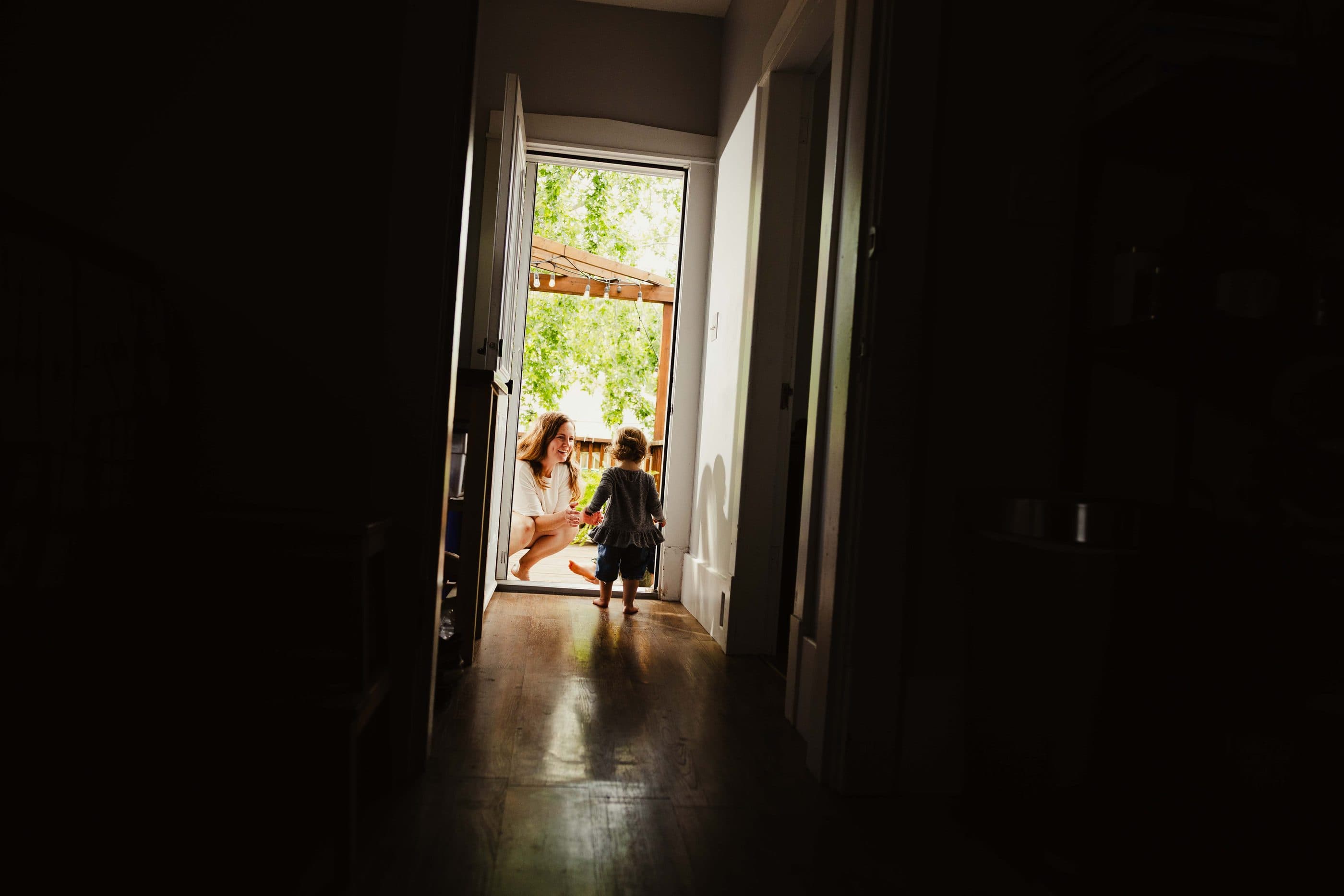 Light falling through an open doorway onto a wooden floor