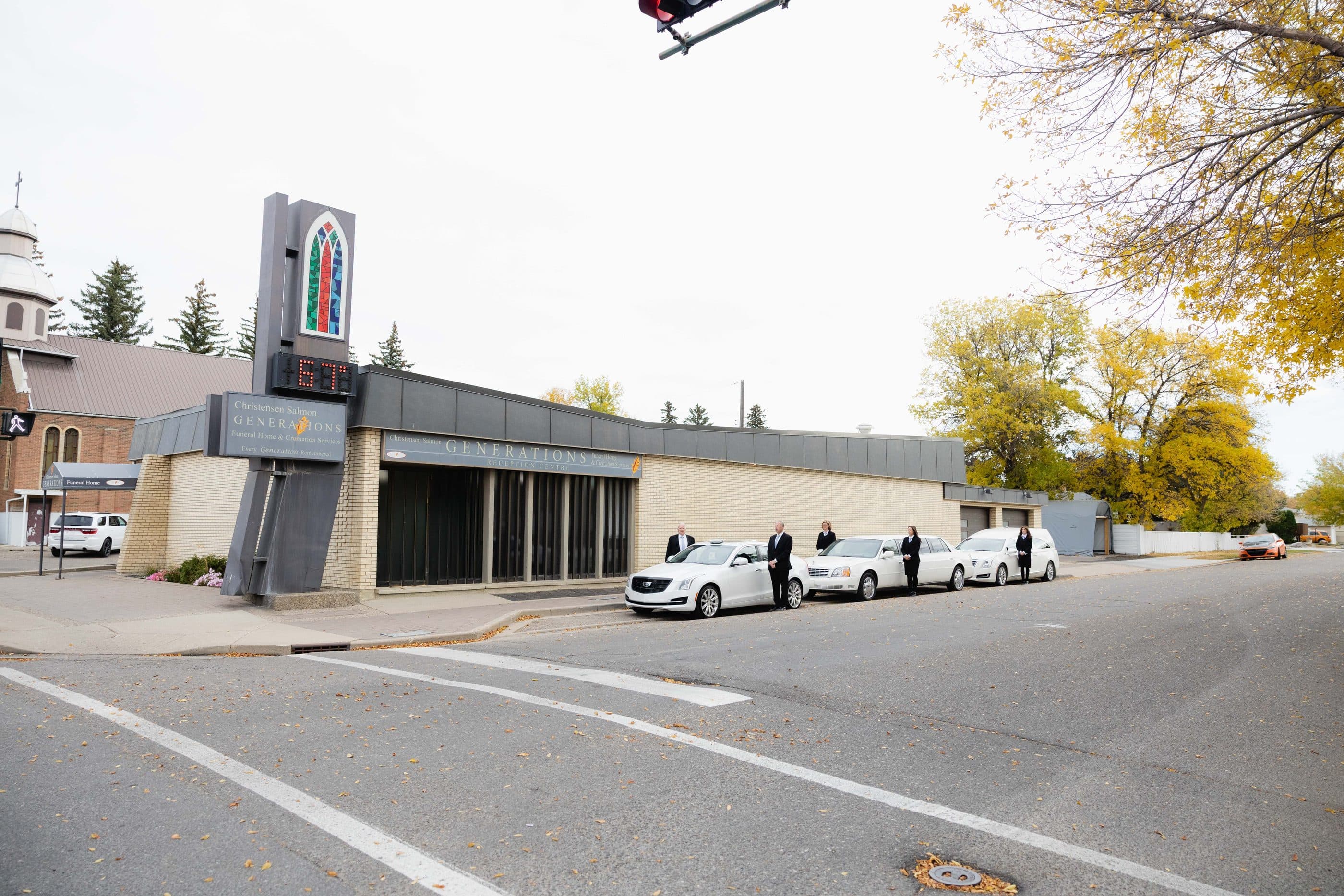 The Christensen Salmon Generations funeral home on 13 Street North, with autumn trees along the street