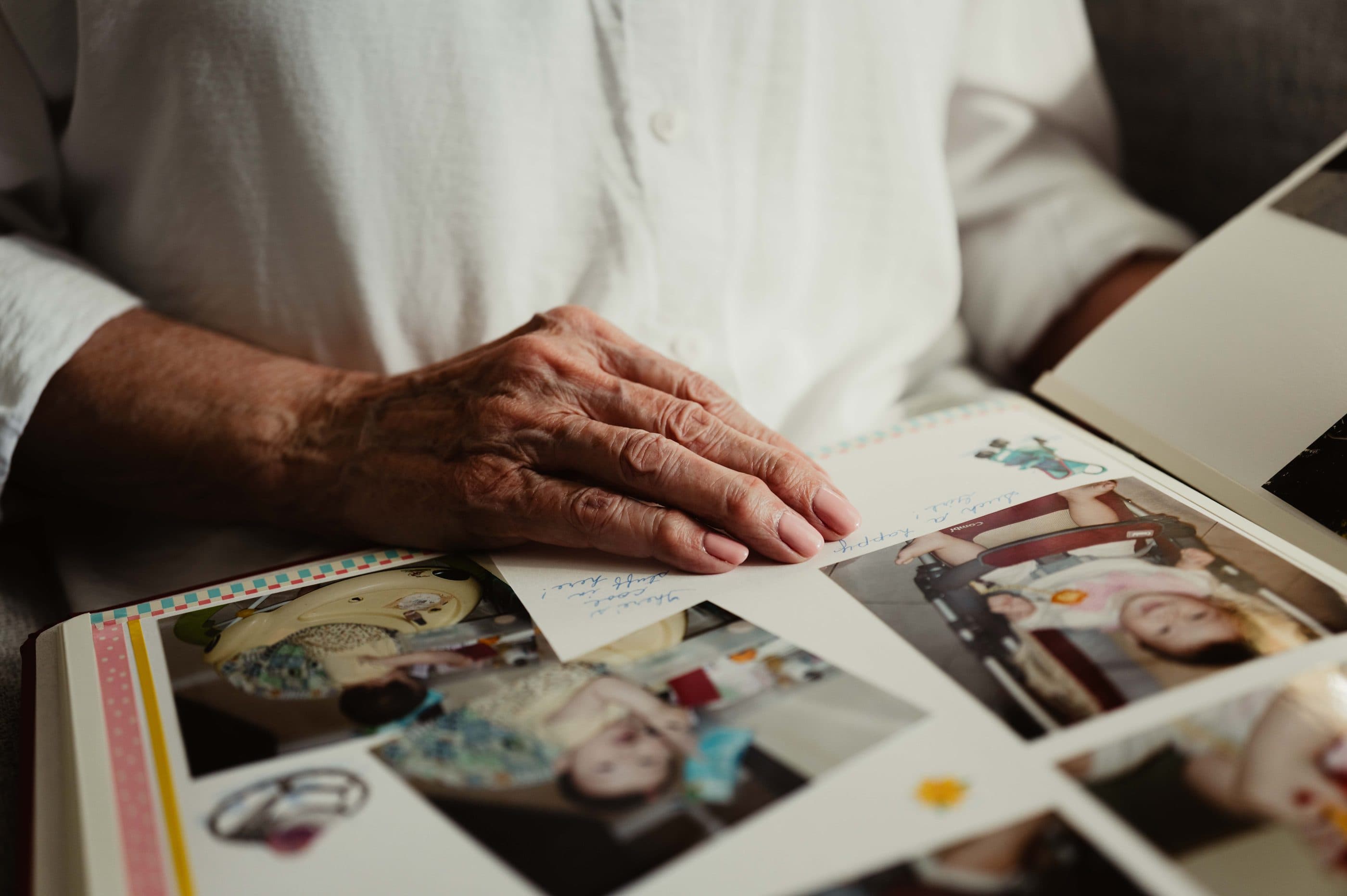 Hands resting on an open family photo album
