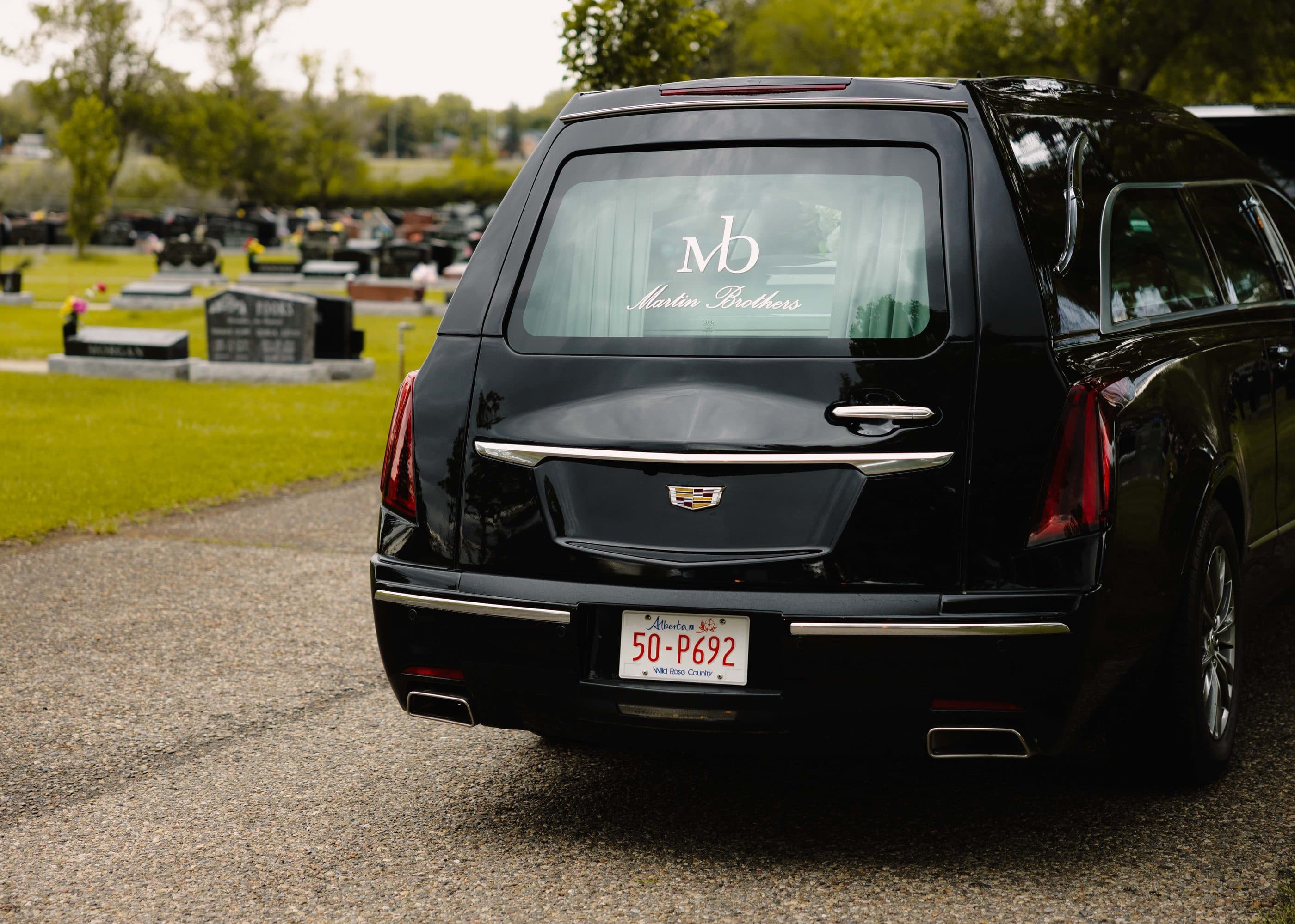 The hearse waiting on the cemetery road