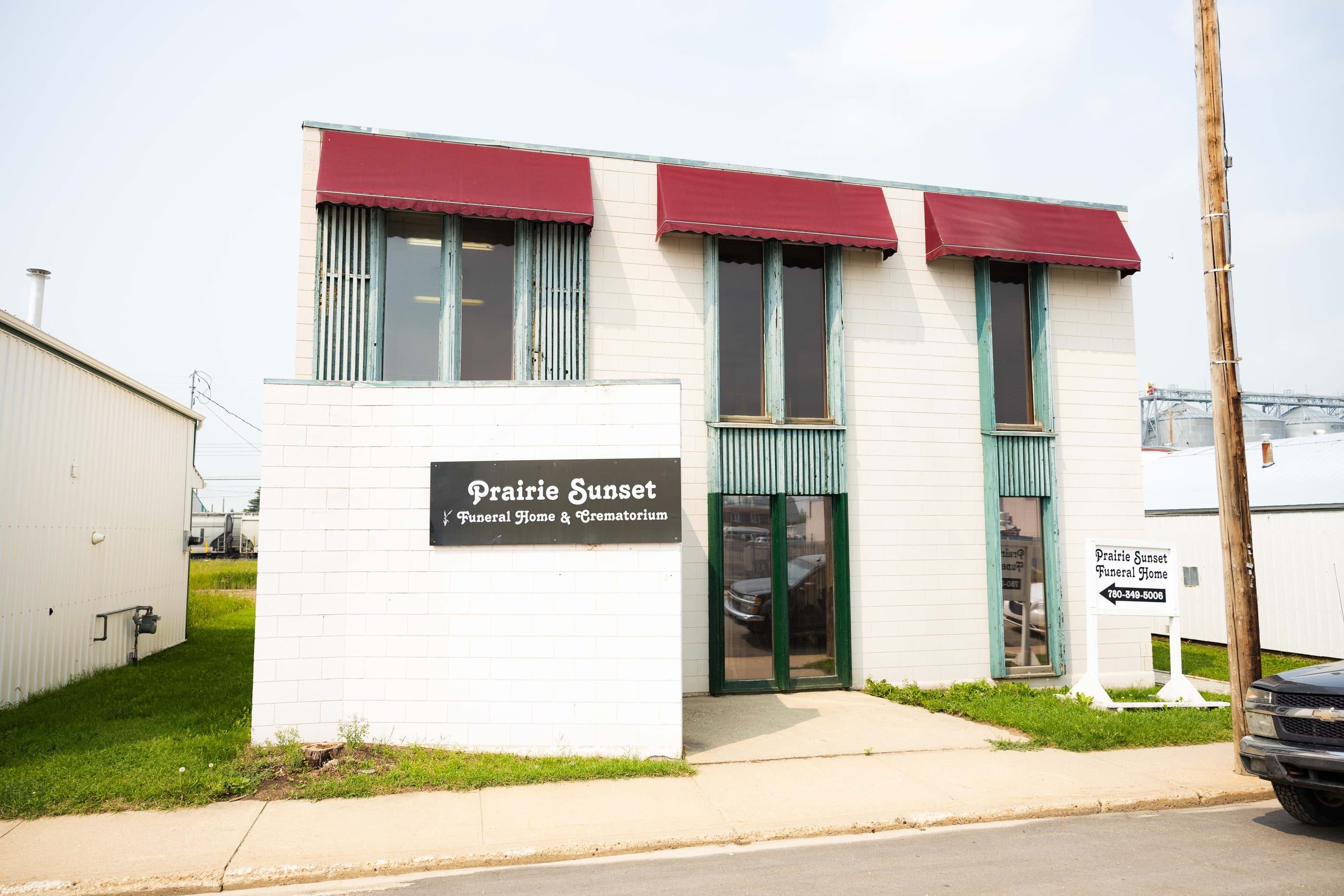 Prairie Sunset Funeral Home & Crematorium, its sign beneath red awnings on a Westlock street