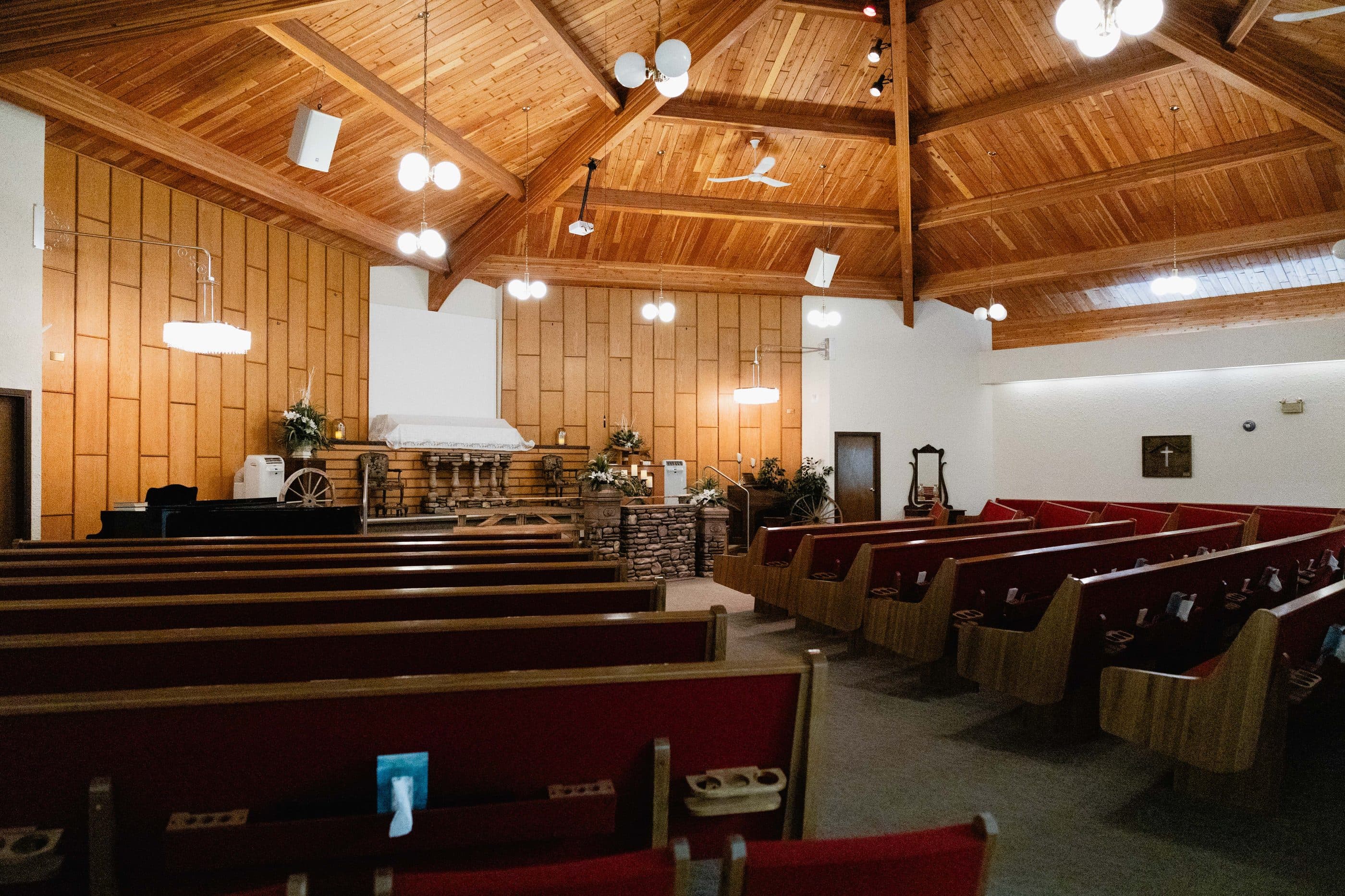 The chapel interior, with its vaulted wooden ceiling and rows of pews
